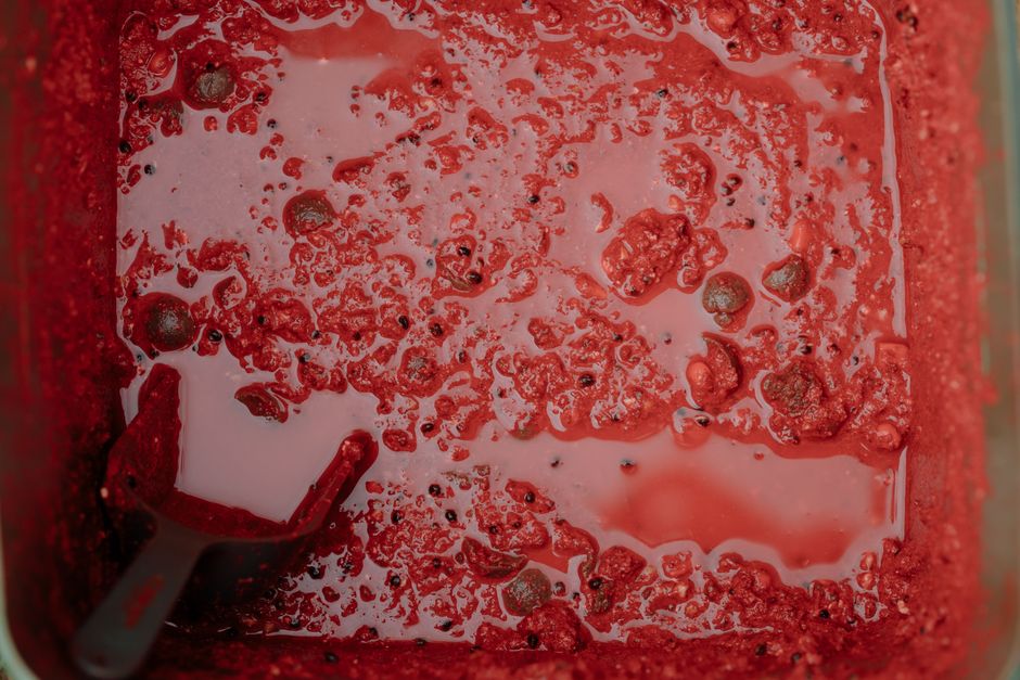 Detailed view of red fish bait with a scooper, showcasing texture and color.