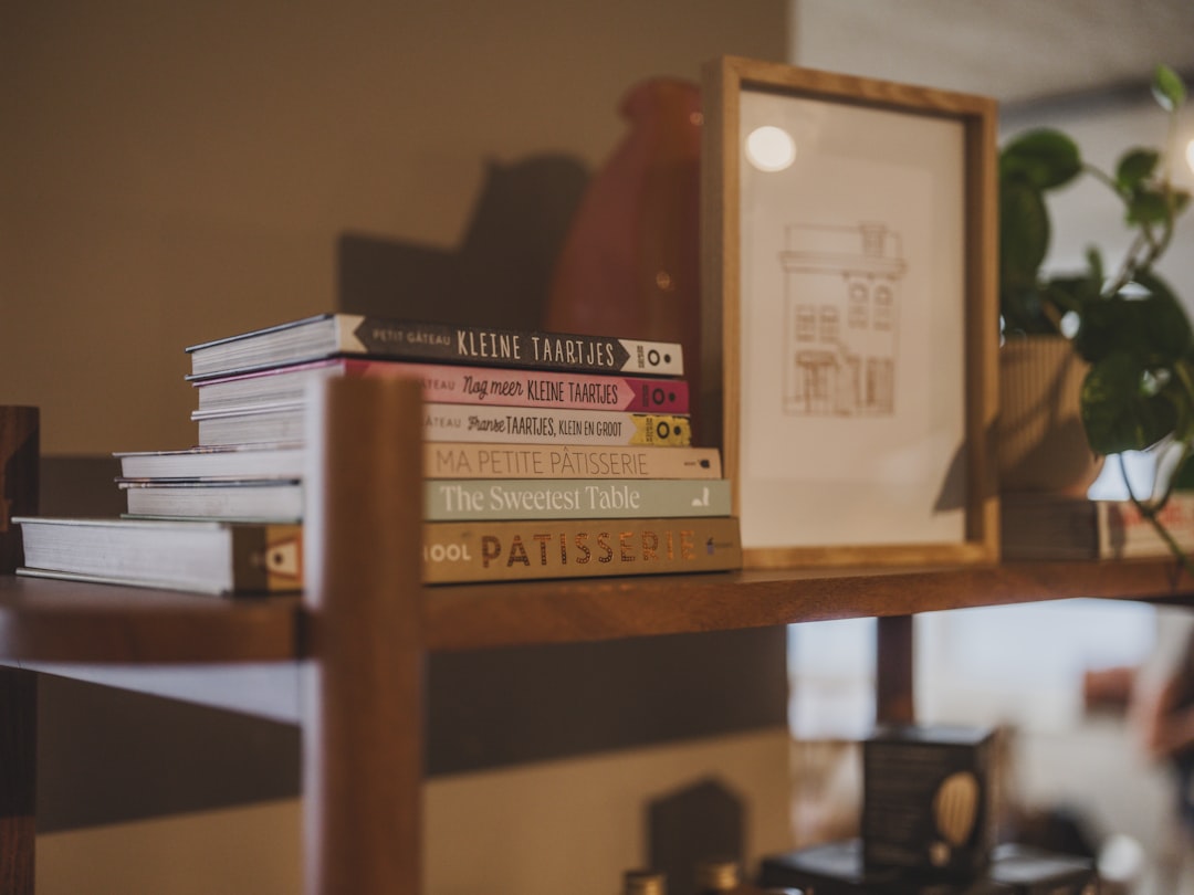 Stack of books on a wooden shelf